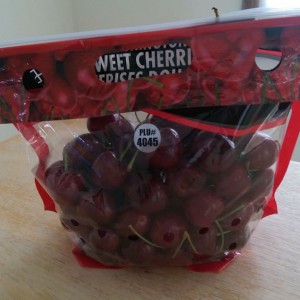 Plastic bag filled with cherries and labeled with the PLU number.