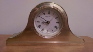 Shiny brass analog clock.