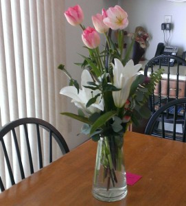 Flowers in a glass vase on the kitchen table.