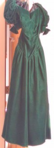 Long green velvet dress with short puffy sleeves.