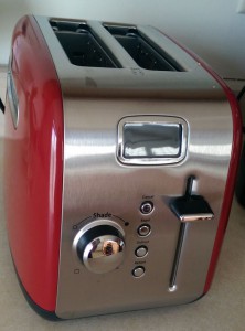 New red toaster with display screen.