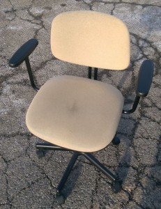 Old desk chair in the parking lot of the thrift store.