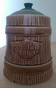 Brown ceramic cookie jar that says "Cookie Churn" and has a metal lid.