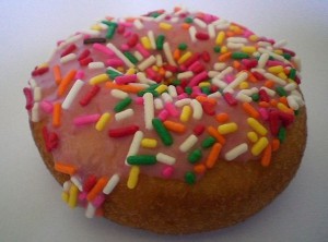 Donut with multicolored sprinkles.