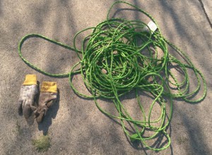 Old green extension cord and grimy gardening gloves.