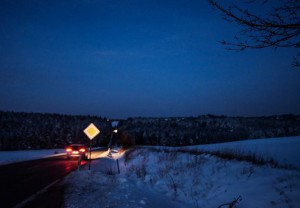 Car on a lonely road on a winter night.