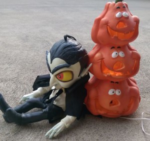 Plastic jack-o-lantern with vampire doll.