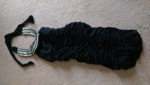 Black dress with silver sequin loop at neckline.