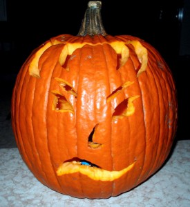 Pumpkin with carved face and skeptical expression.