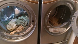 Front-loading washer and dryer, full of towels.