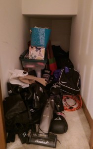 Cluttered closet under the basement stairs.