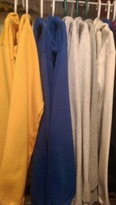 Hoodie sweatshirts on hangers in my closet.