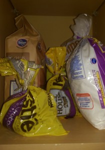 Flour, sugar, and two half-empty bags of chocolate chips on a shelf.