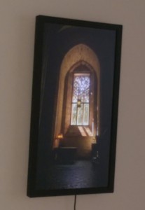 Flat-screen display showing a church window with a dark and quiet area beneath.