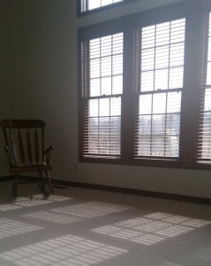 My living room with open wooden blinds on a hazy day.