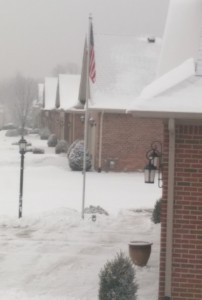 Row of suburban brick houses on a snowy day.