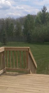 My backyard after the grass was cut and the deck power-washed.