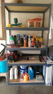 Particle board garage shelves in a metal frame.