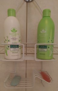 Nature's Gate calming shampoo and conditioner in shower caddy.