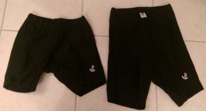 Two pairs of black rowing shorts, women's and men's.