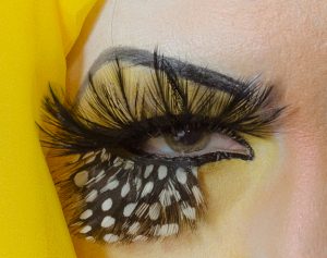 Eye decorated to resemble a bird's head.