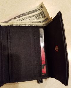 Wallet with edges of small bills showing.