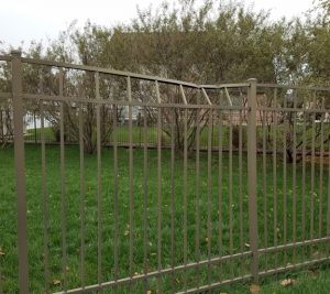 Aluminum fence bent at top by a leaping deer.