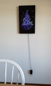 Animated art of a purple Christmas tree with sparkling stars.