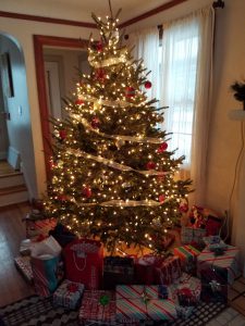 Brightly lit Christmas tree with presents