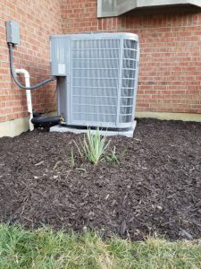 New air conditioner with fresh mulch around it.