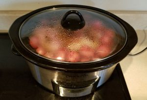 Pot roast with small red potatoes in a Crock-Pot.
