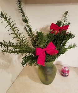 Juniper and yew branches with red holiday bows.