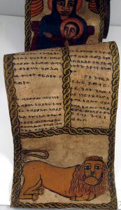 Ancient parchment prayer scroll with illustrations.