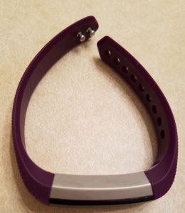 Fitbit with small purple band.