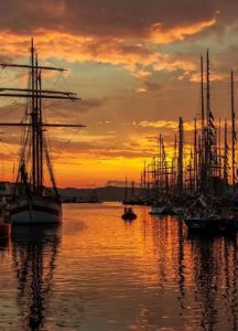 Ships under a sunset sky.