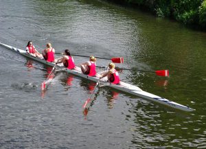 College women rowing a four.