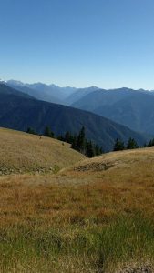 Photo of mountains behind hills.