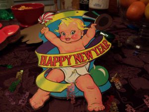 Cartoon image of a baby with a Happy New Year sash.