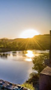 Sunrise over a still pond.