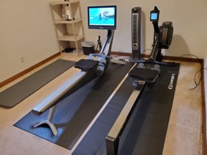 Photo of a new Concept2 rowing machine next to a Hydrow.