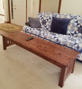 Wood coffee table in front of couch.