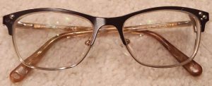Photo of old eyeglasses with missing decorative dots.