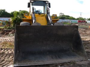 Photo of construction machinery on a muddy site.