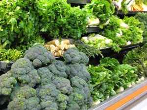 Photo of vegetables on grocery shelves.