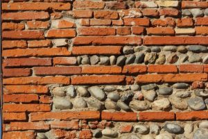 Photo of a wall made of bricks and stones.