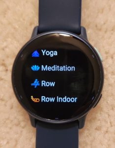 Photo of Garmin tracker showing activities: yoga, meditation, row, row indoor.