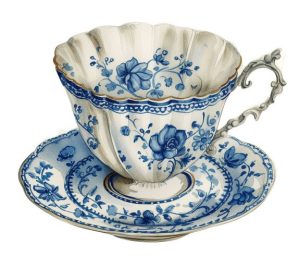 Teacup and saucer with a blue floral pattern.