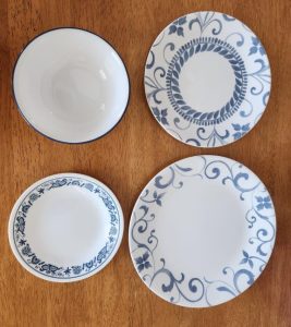 Photo of a white bowl and three plates with different blue patterns.