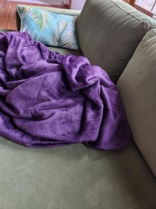 Photo of a purple blanket on my couch.