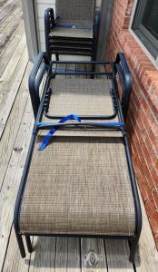 Chairs strapped down on the deck.